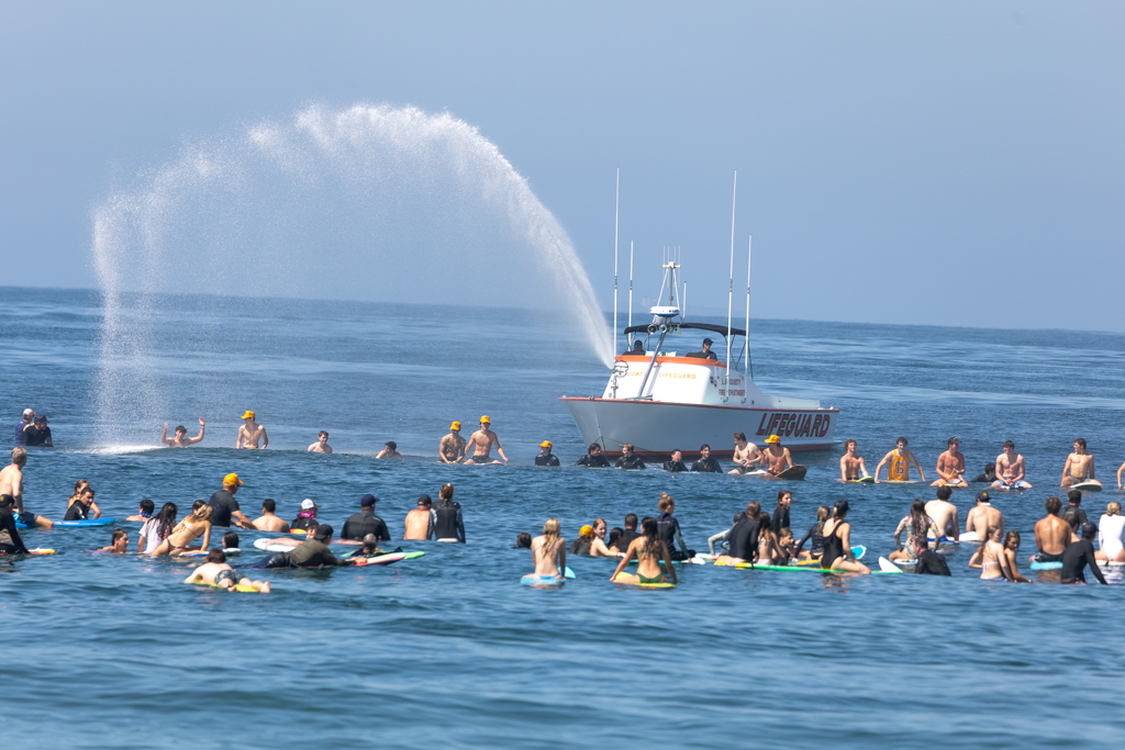 Baywatch Redondo Beach sends up an arch from its watergun in tribute to Braun Levi. Photo by Kevin Cody